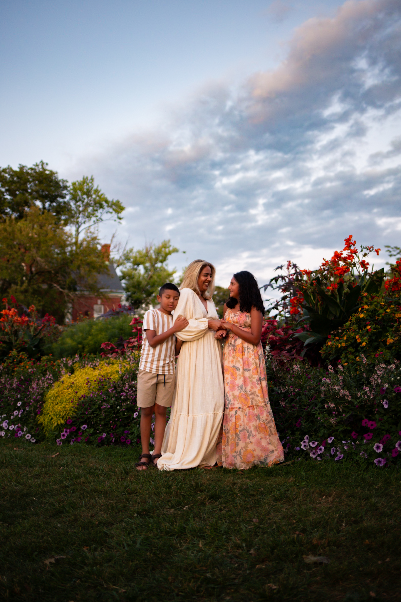 mother and children standing during golden hour in front of wildflowers in queens nyc