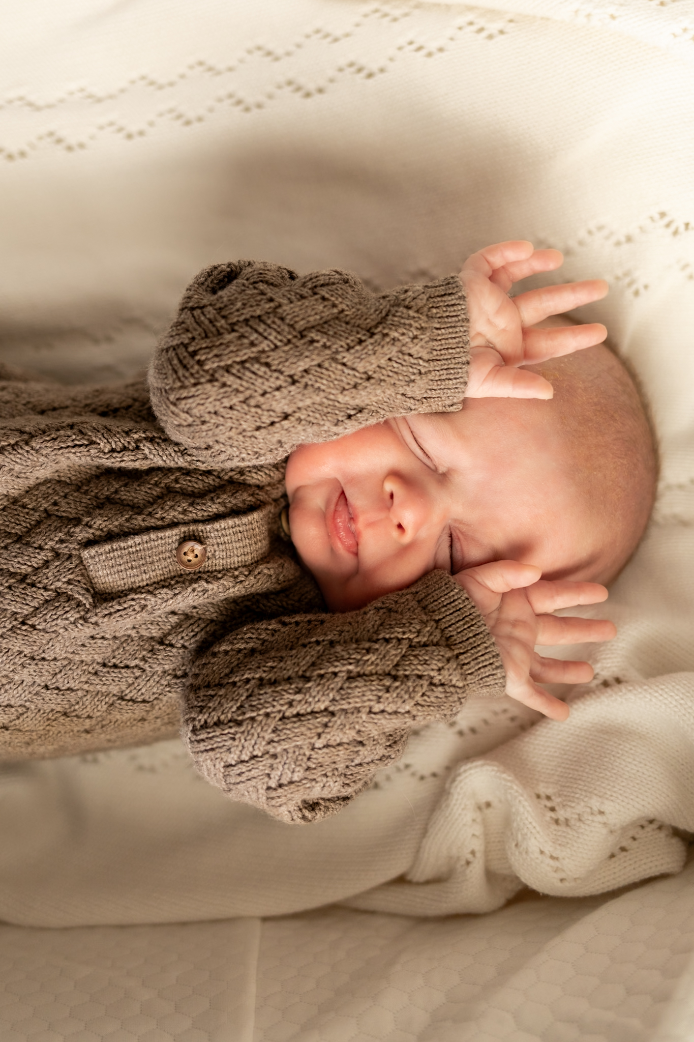 newborn baby stretching during in home photo session